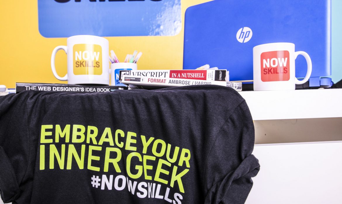 nowskills cups. shirt and laptop